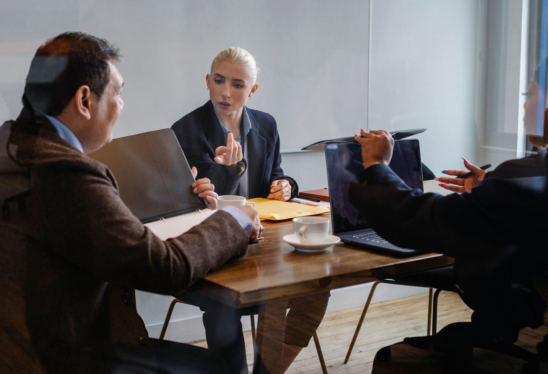 Financial advisors meet with clients in a modern wealth management office as RIA consolidation reshapes the advisory market.
