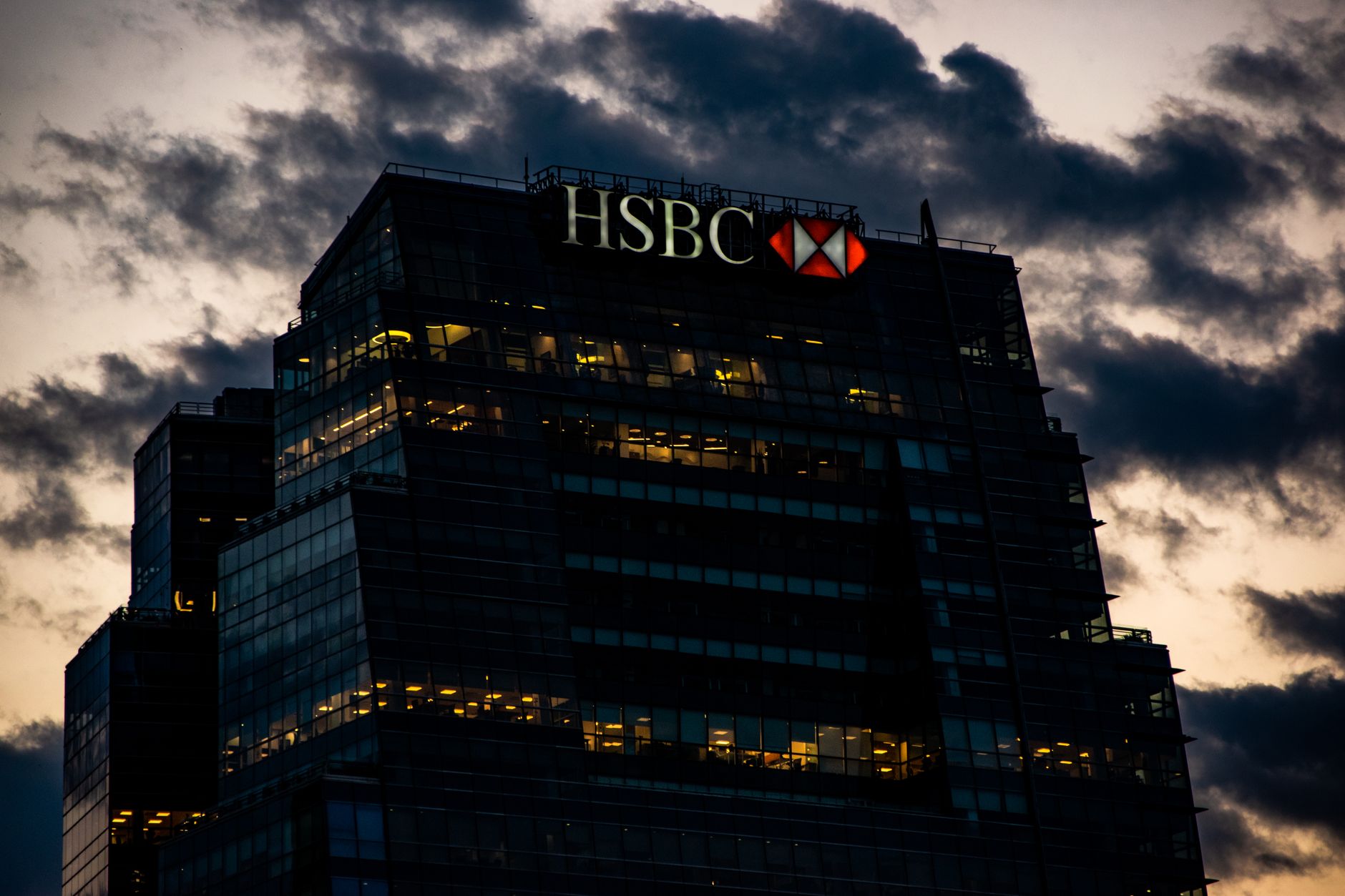 Bank executives and financial professionals review earnings results highlighting trading and wealth management performance.