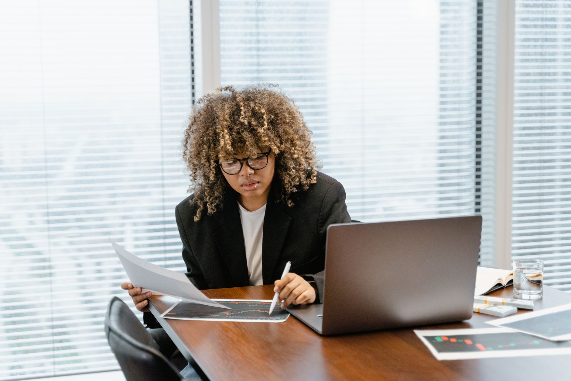 Financial advisors discuss succession planning strategies in a modern wealth management office environment.