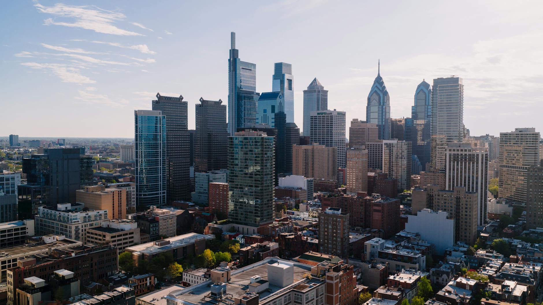 A city skyline with office workers analyzing economic data on screens, representing the U.S. labor market report.