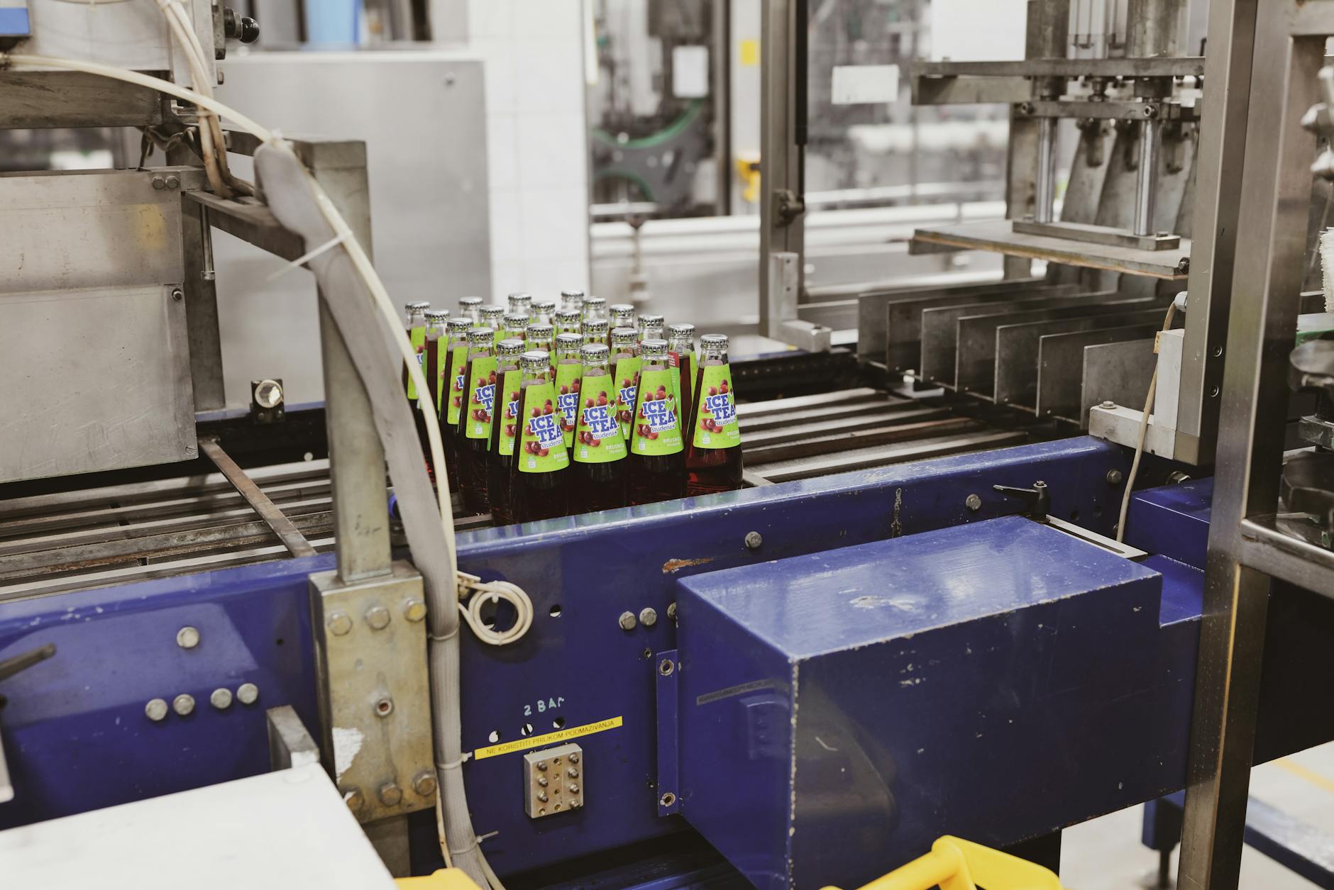 Workers monitor equipment on a U.S. factory floor as manufacturing activity rises and cost pressures build.