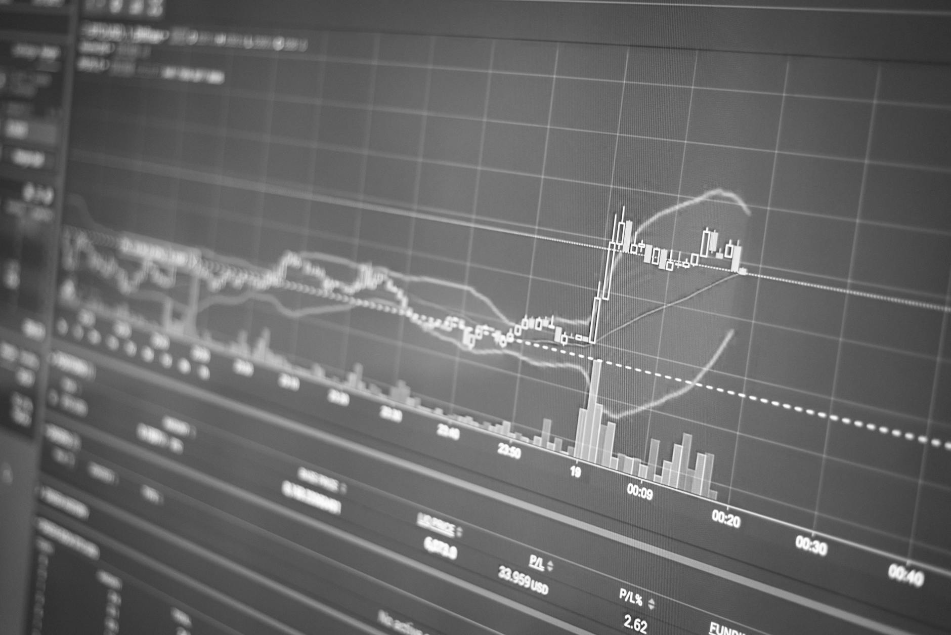 A trading desk screen displays ETF flow data as investors review fund allocation trends.