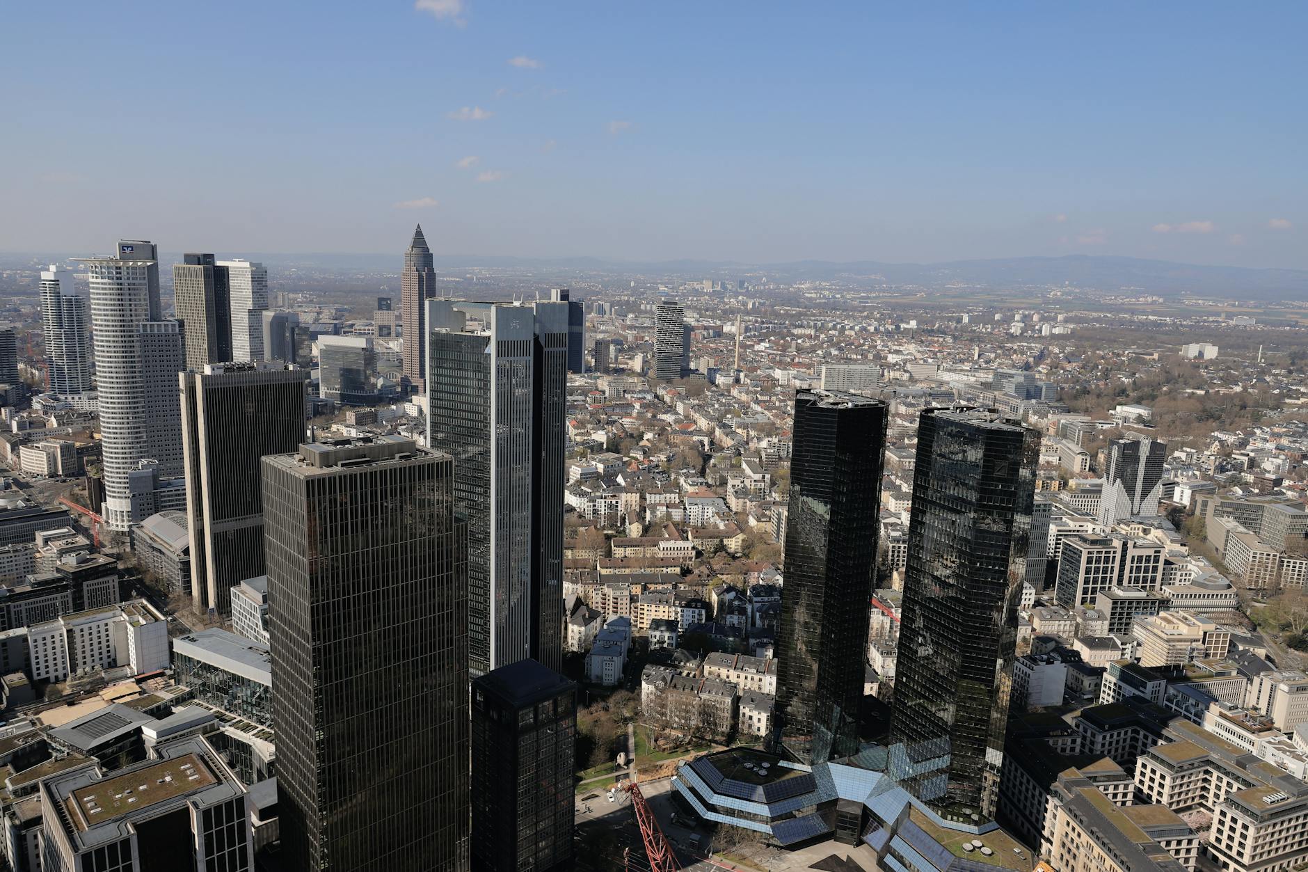 Traders monitor European bank bond issuance activity on screens in a financial trading floor setting.