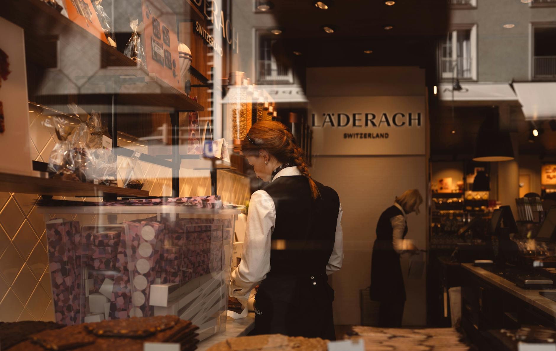 A small business merchant in Europe accepts a contactless smartphone payment from a customer using a mobile tap-to-pay system.