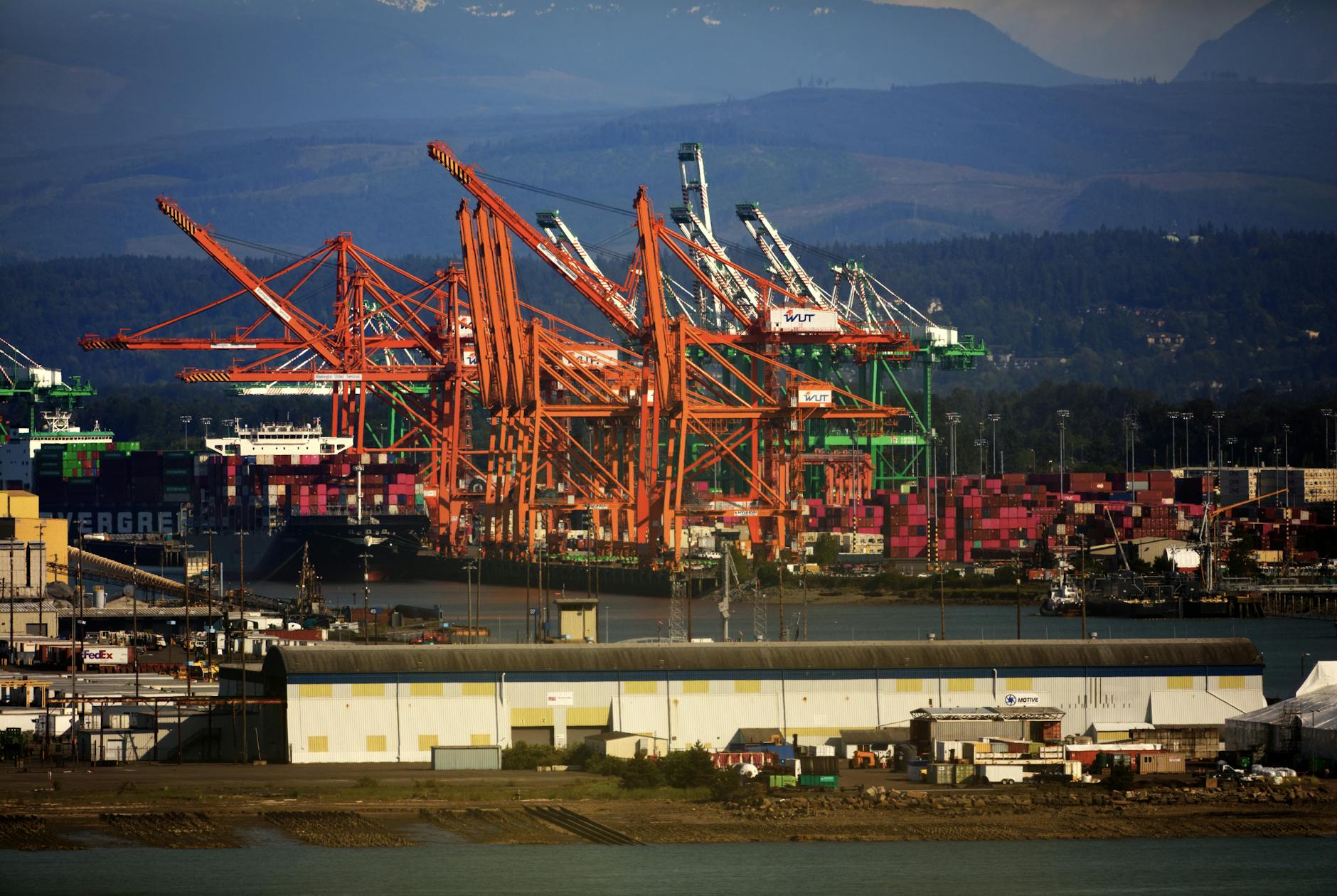 Cargo containers at a European port illustrate the EU-U.S. trade flows affected by the provisional tariff agreement.