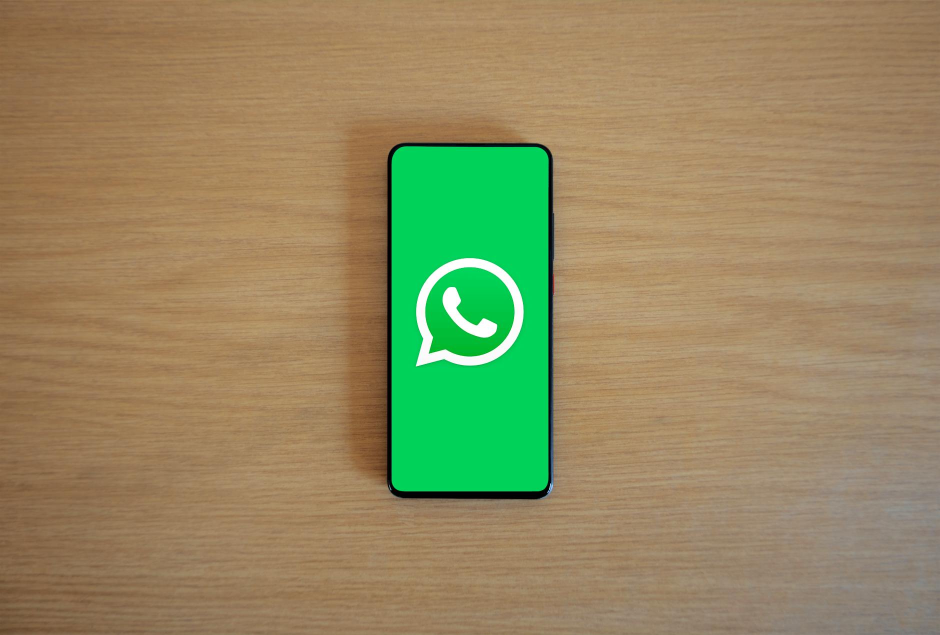 A smartphone showing WhatsApp near a Meta logo as legal scrutiny over encrypted messaging privacy claims intensifies.