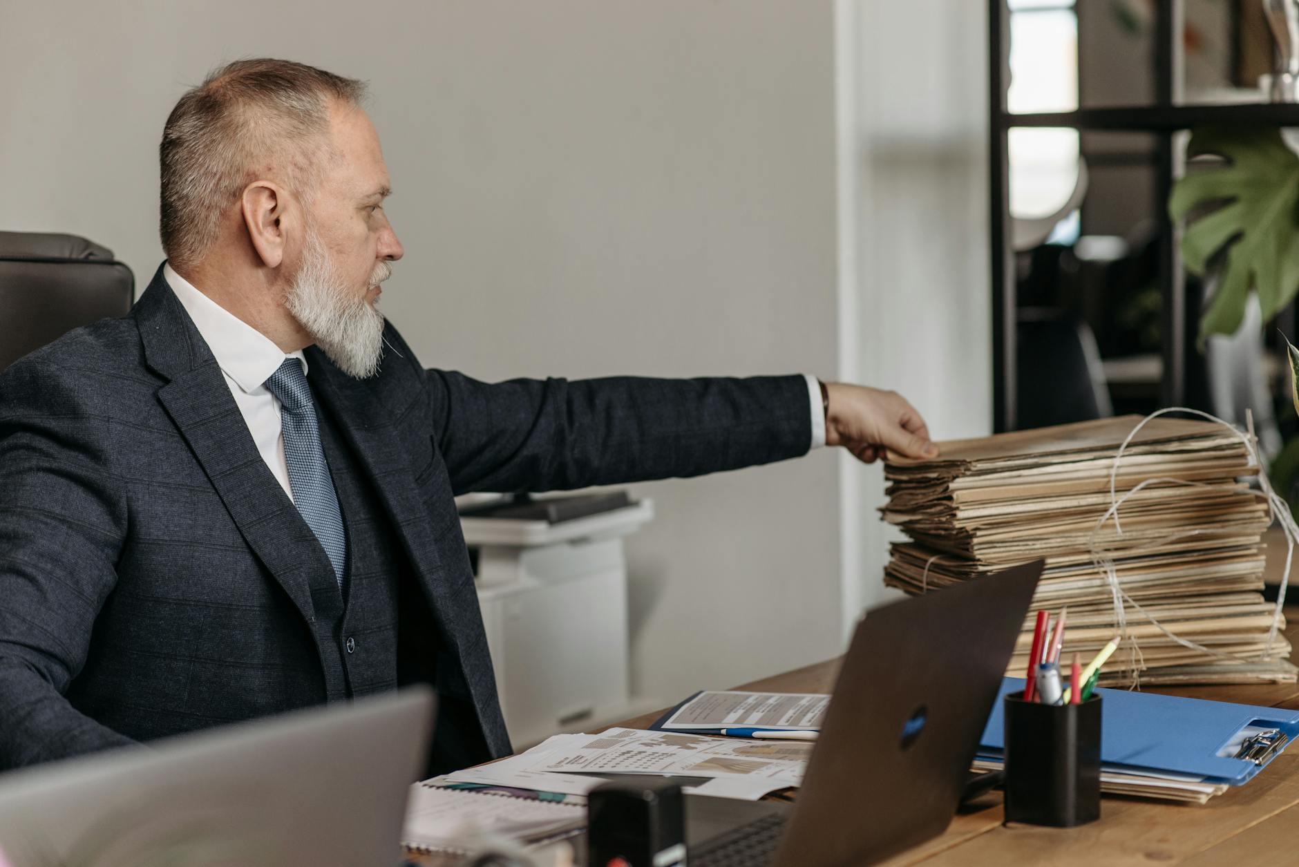 A financial adviser reviews portfolio data with clients in a modern wealth management office.
