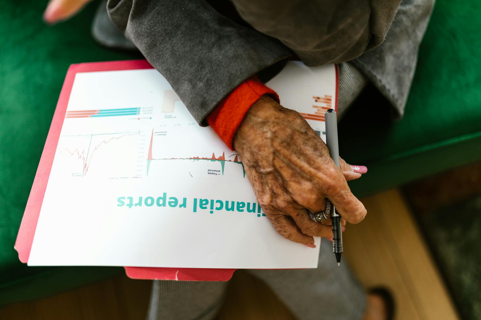 A financial advisor reviewing retirement income portfolio strategies with an elderly client at a desk