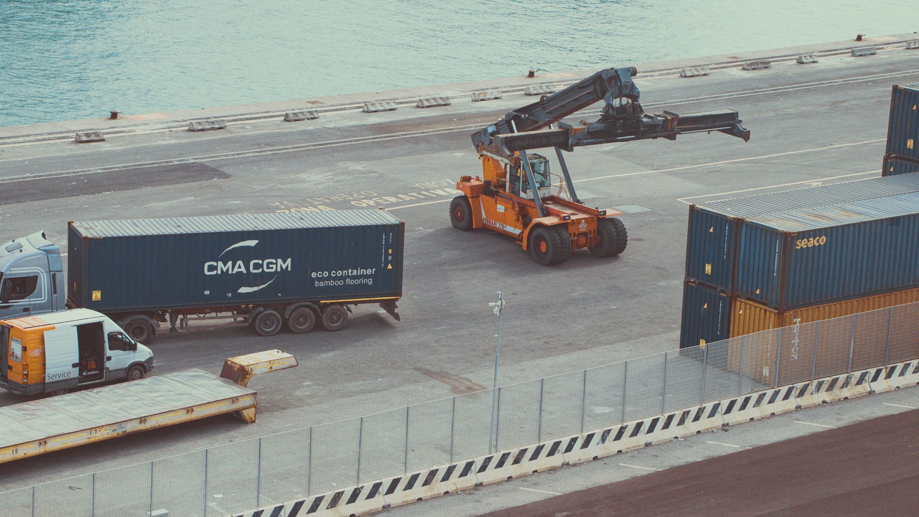 Trucks and freight containers at a logistics terminal representing Universal Logistics Holdings’ second-quarter earnings.
