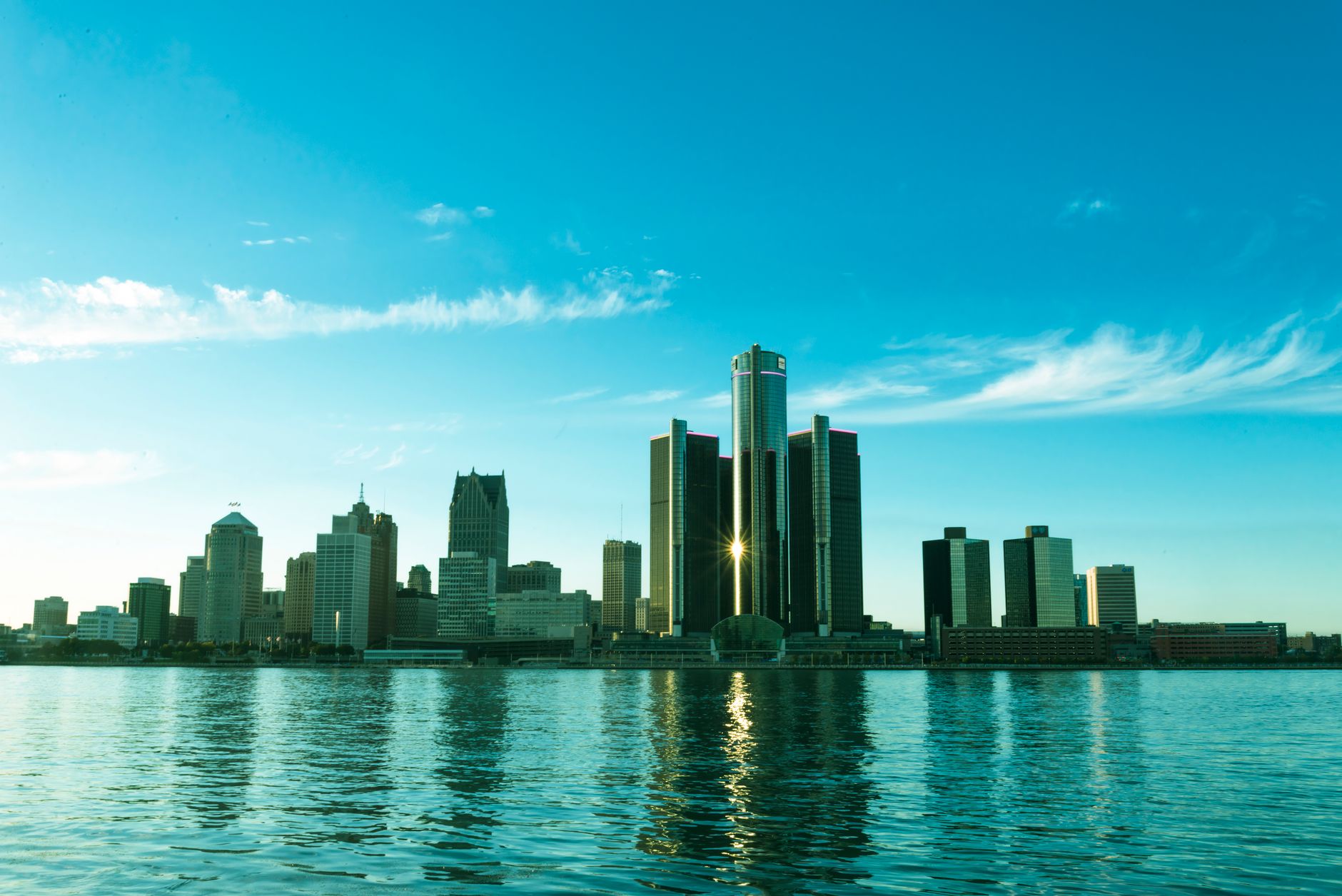 A digital payments network graphic overlays the Michigan skyline to represent Alchemy Pay’s newly approved money transmitter license.