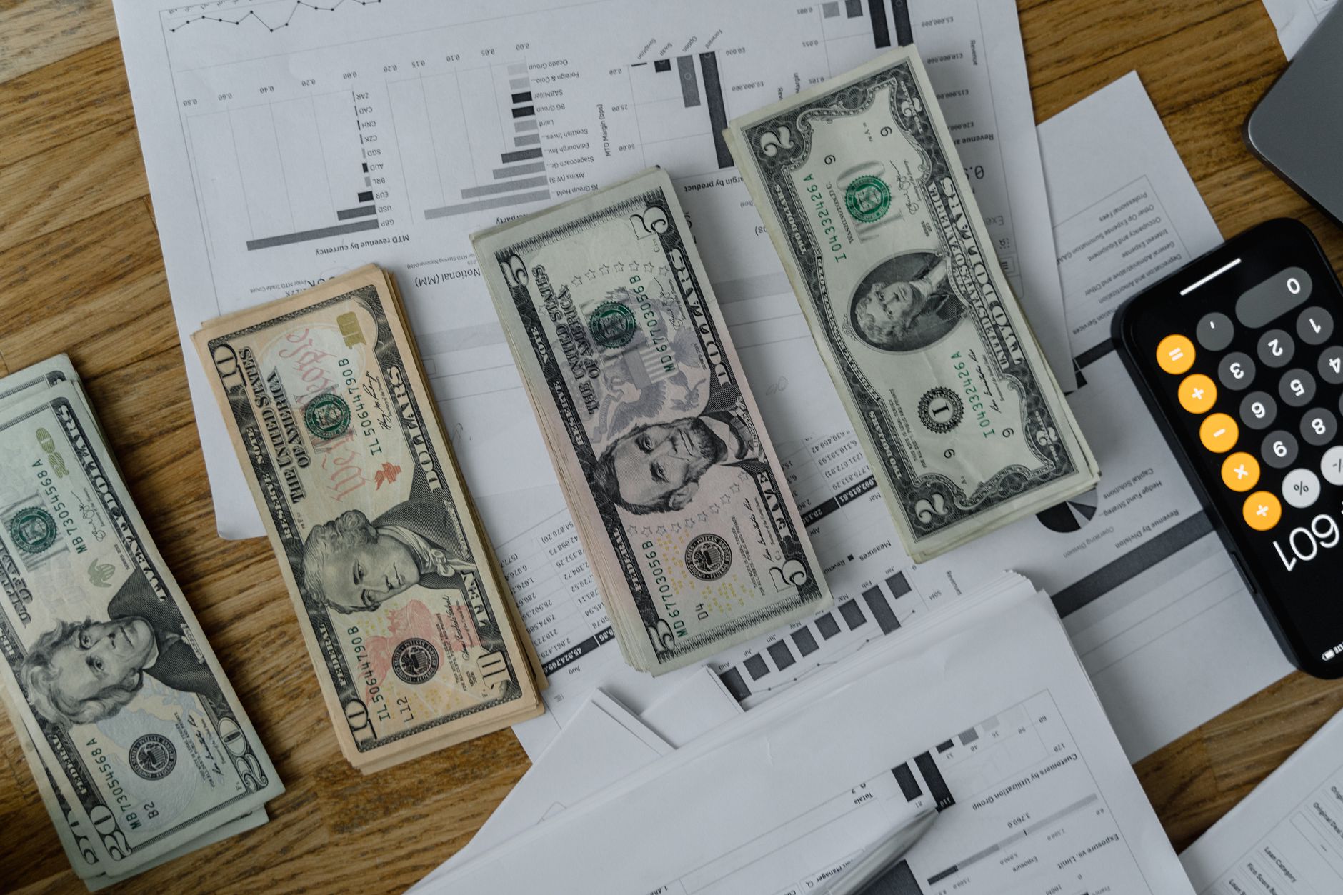 Financial advisers review portfolio growth and client-acquisition data during a wealth-management strategy meeting.