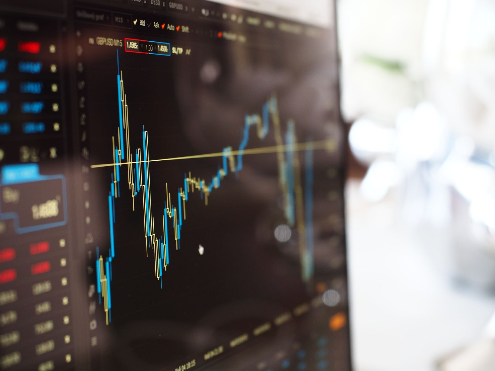 Financial market screens illustrate the proposed First Trust OpenAI-linked target income ETF as its regulatory timeline is extended.
