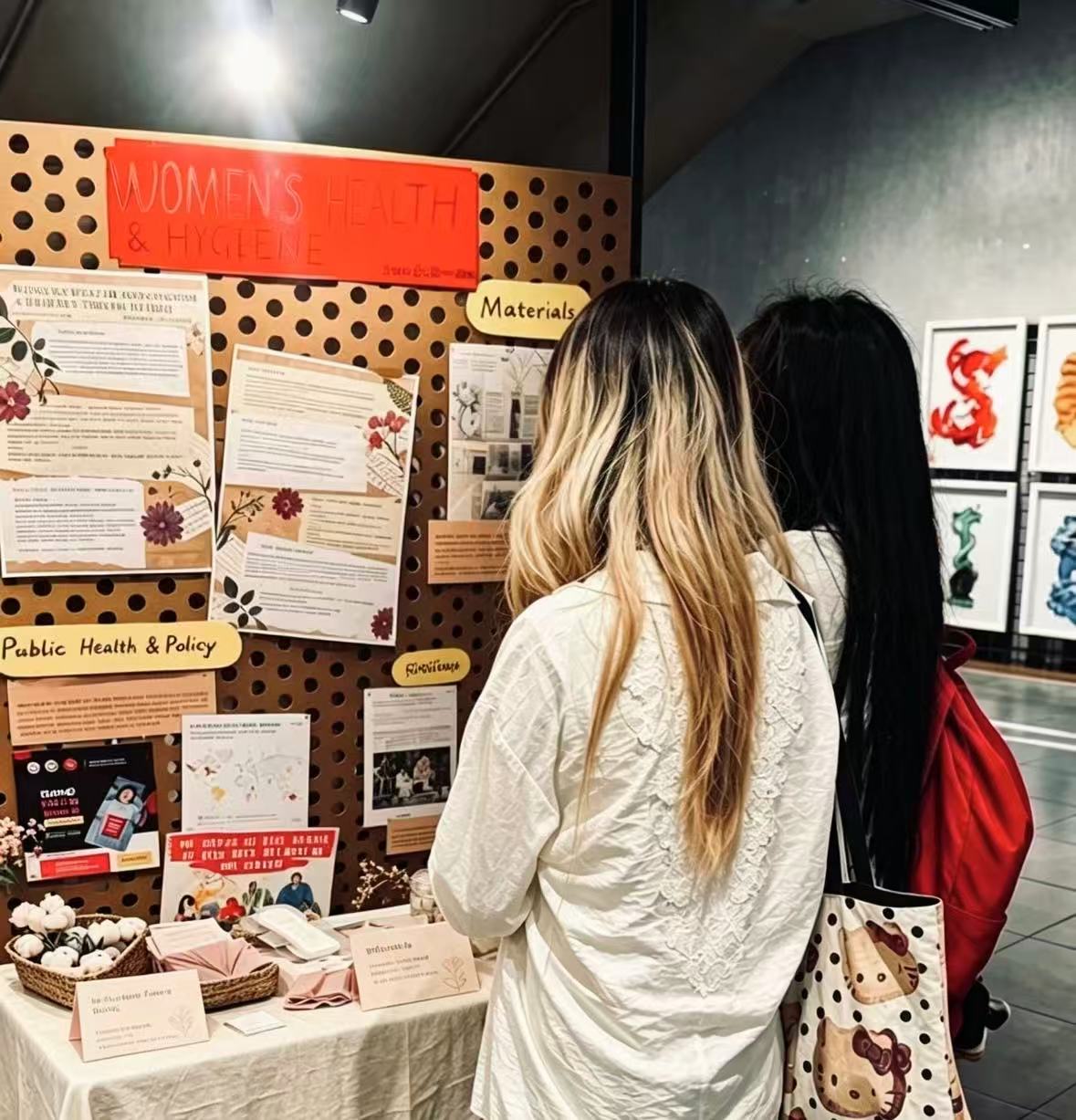 Visitors read "Women's Health and Hygiene: A Journey Through Time," an exhibition by SCIE student Momo Zha.